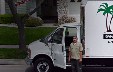 The Rancho Rain Gutters factory on wheels truck with a crew member at a home in Upland